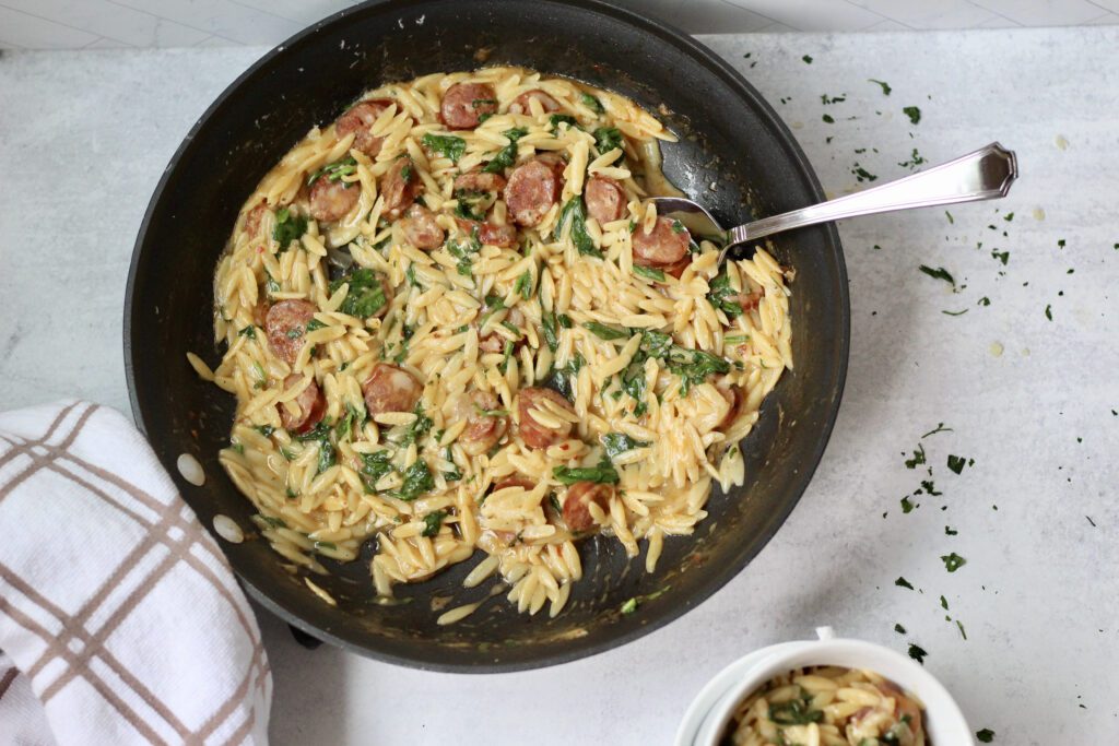 Cajun chicken sausage orzo spooned