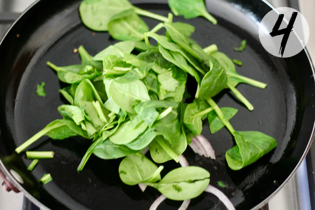 Sauté spinach and red onions