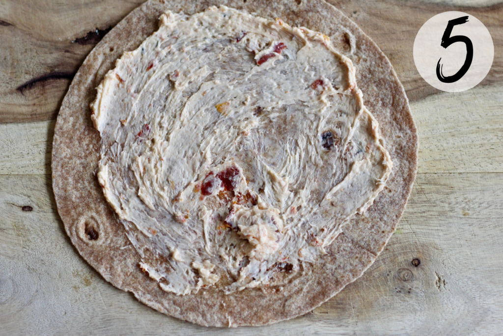 Spread sun-dried tomato mix on tortilla