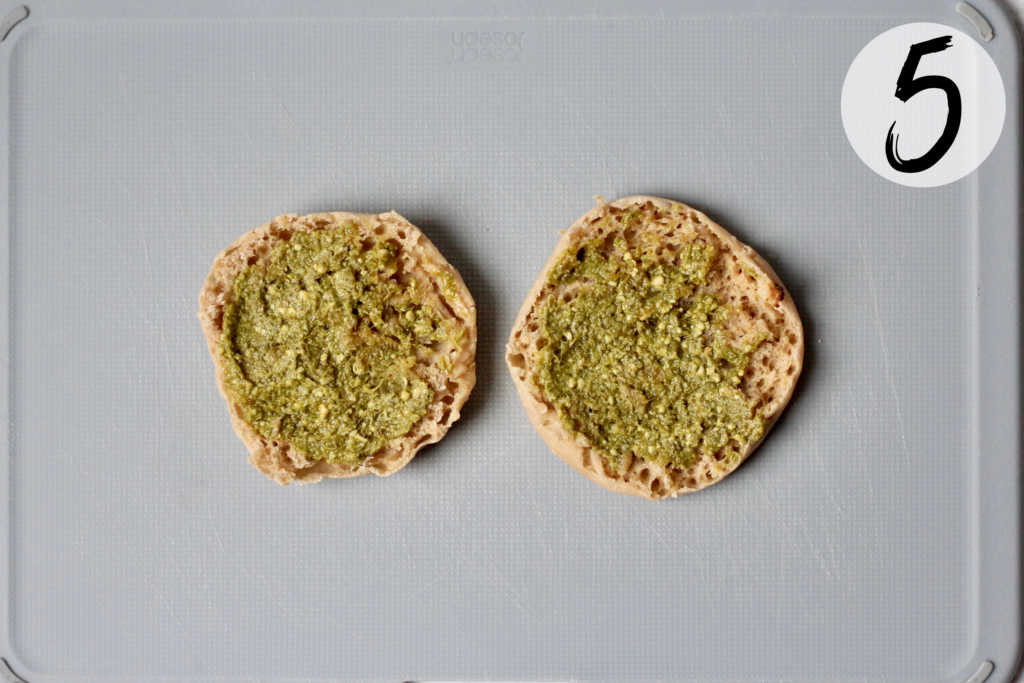 Spread pesto on whole wheat english muffins
