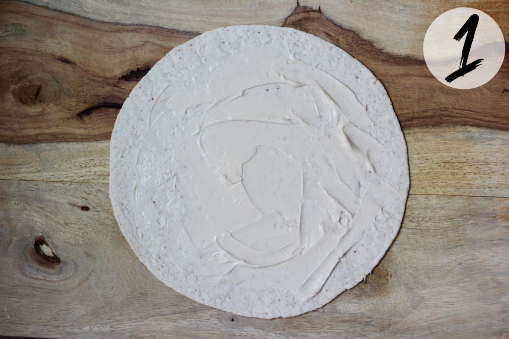 Spread cheese on the tortilla