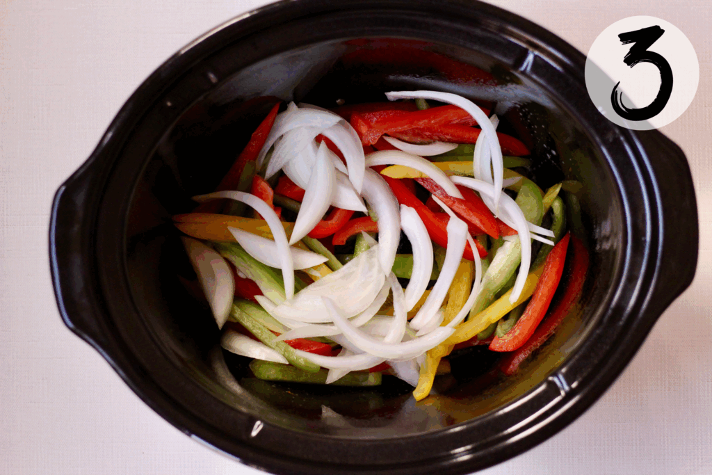 Add half peppers and onions to slow cooker