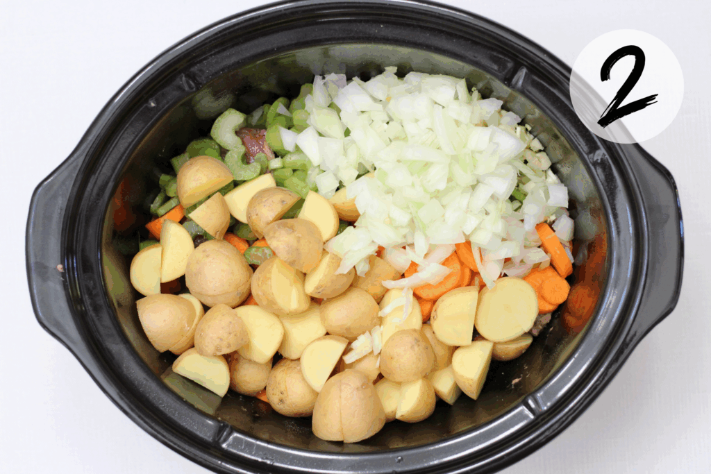 Add beef, potatoes, carrots, celery, onion and garlic in a slow cooker