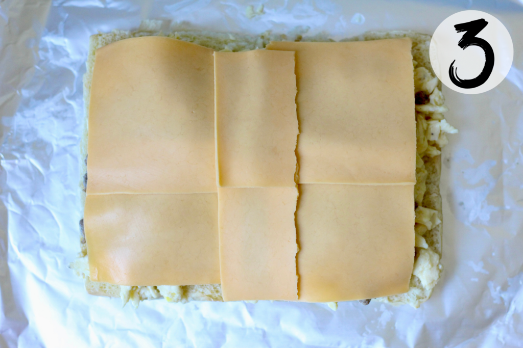 American cheese slices arranged over the egg and turkey sausage filling