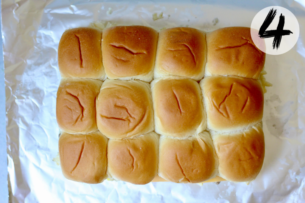 Top half of the Hawaiian rolls placed over the sausage, egg and cheese filling