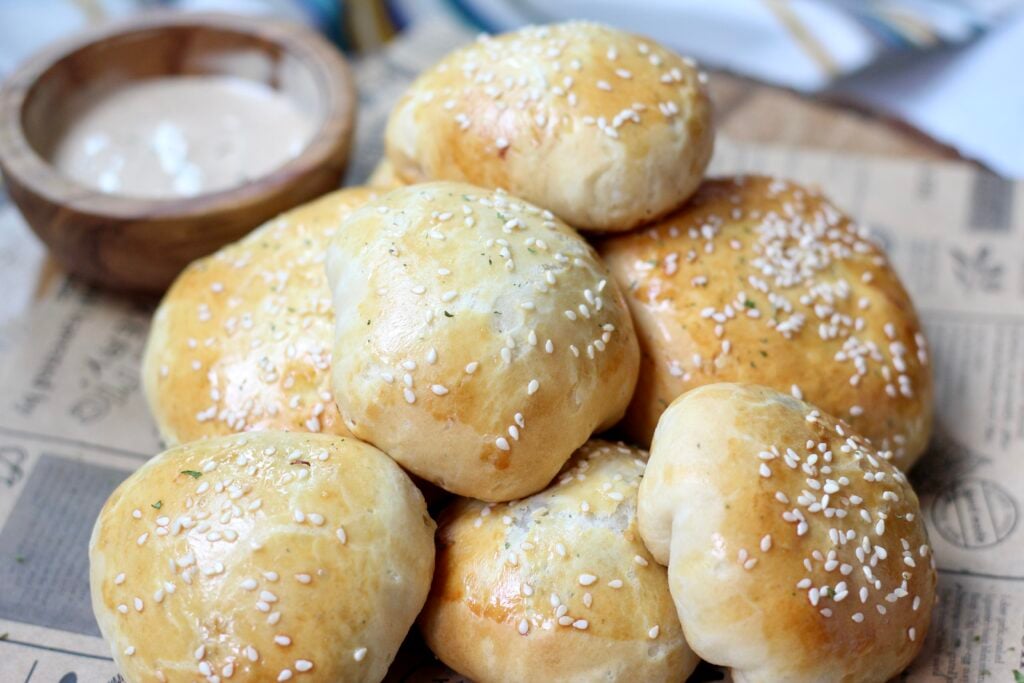 Golden cheeseburger bombs topped with sesame seeds