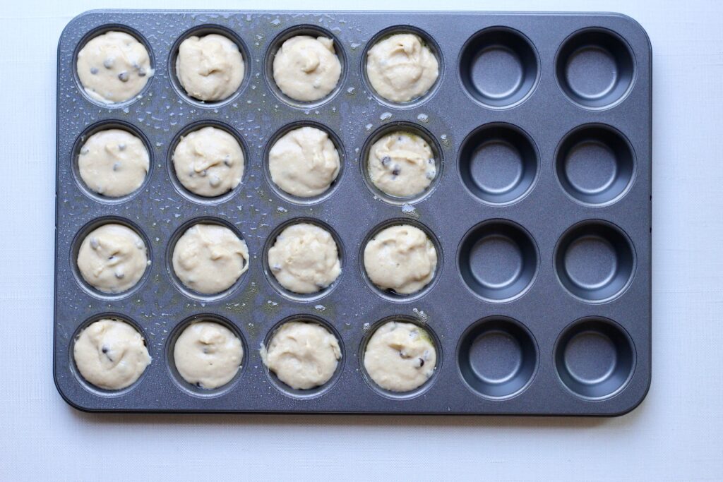 Mini muffin pan filled with Kodiak chocolate chip muffin batter