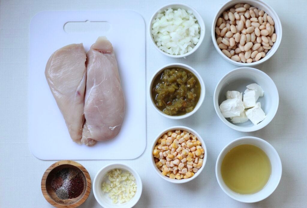 Ingredients for slow cooker white chicken chili arranged on a table.